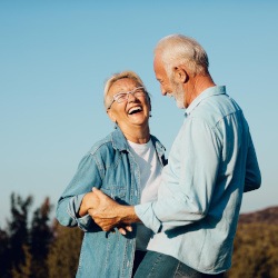 Couple smiling and laughing outside