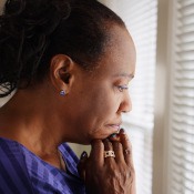 Sad woman looking out her window