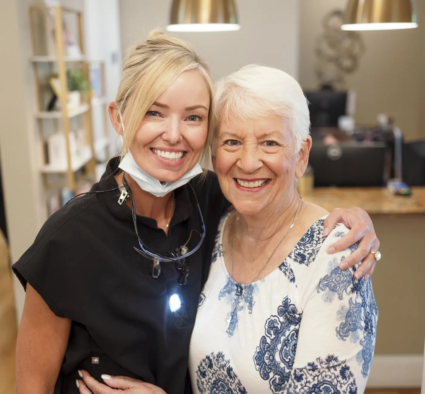 Bell Dental team member hugging a smiling patient