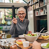 Woman smiling while eating lunch with friend