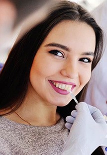Woman having teeth looked at by dentist