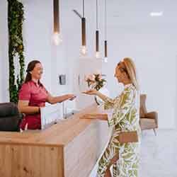 Dental receptionist assists patient