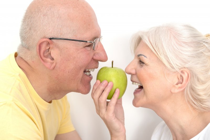 Patients sharing an apple with their dentures